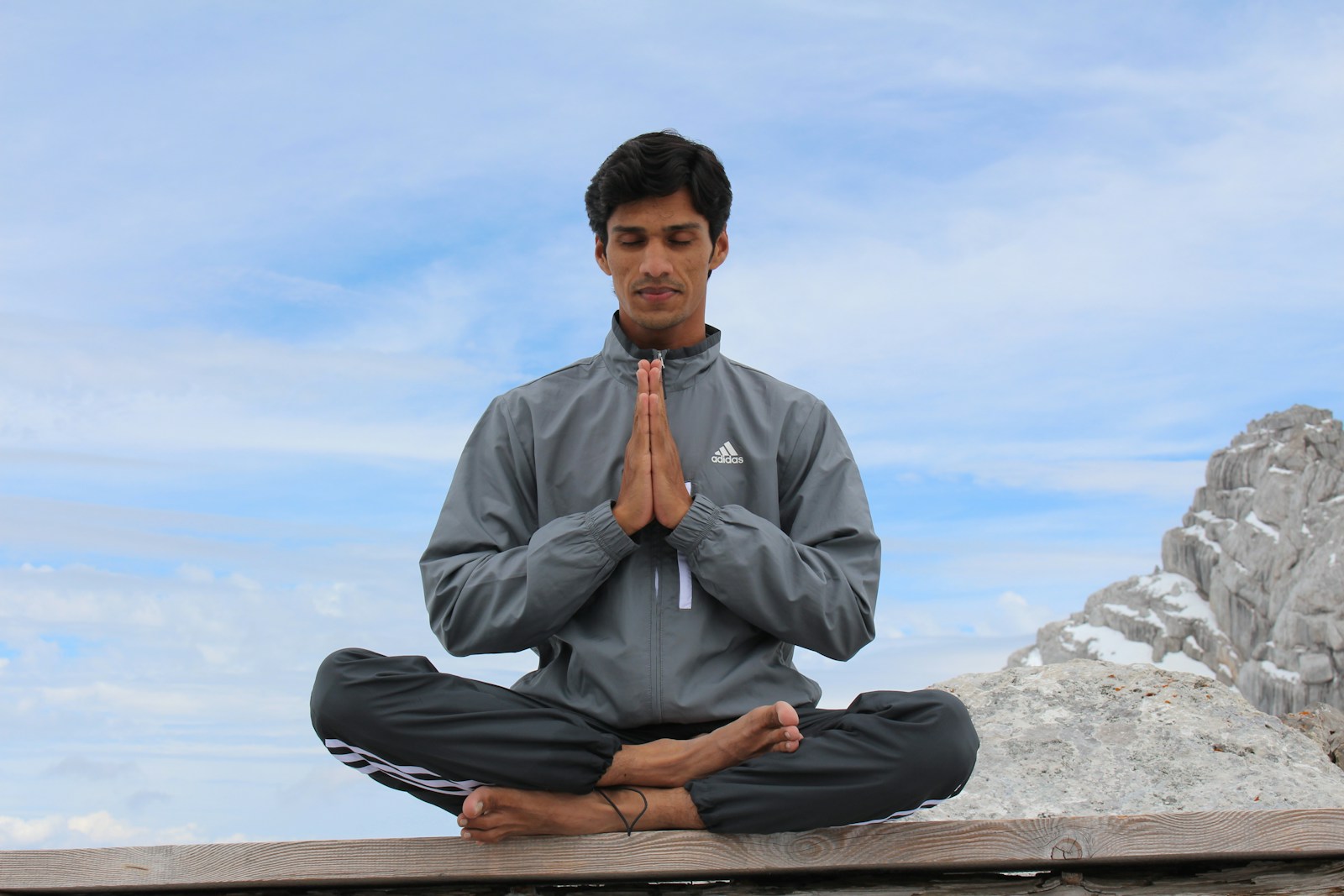 Photo by Indian Yogi (Yogi Madhav) man meditating on brown wooden platform during daytime